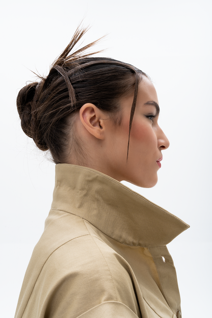 Detail shot of AKANTARA Cropped Short Sleeve Vest in navy and brown, highlighting the design elements