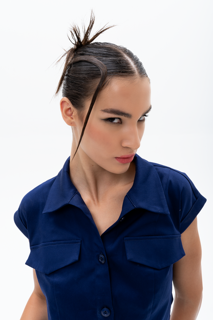 Model wearing AKANTARA Cropped Short Sleeve Vest in navy and brown, styled with casual streetwear